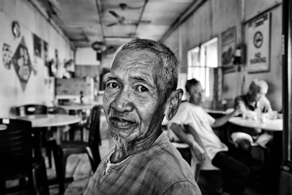 Elderly Man's Warm Gaze by Kieron Long — canvas wall art