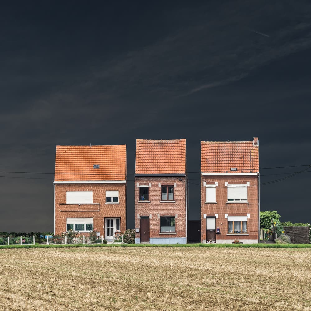 Three Houses Against Dark Sky by Luc Vangindertael (laGrange) — canvas wall art