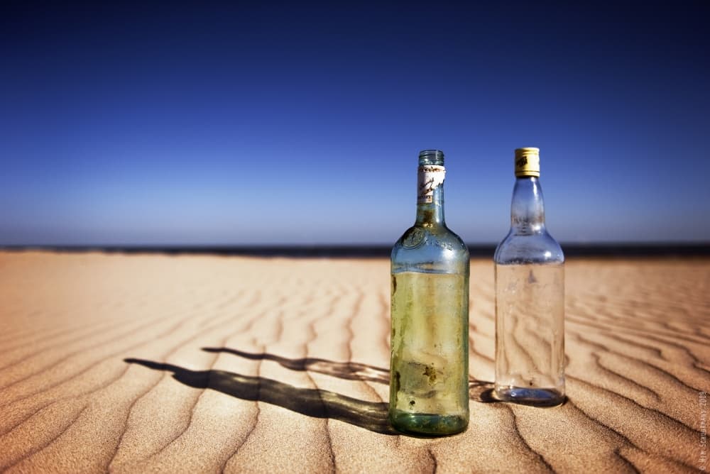 Empty Desert Bottles by Wim Schuurmans — canvas wall art