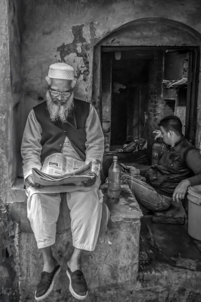 Old Man Reading Newspaper by Corinne Spector — canvas wall art