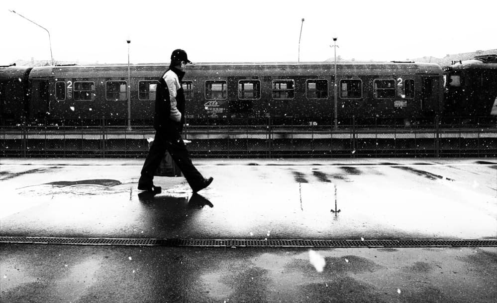 Man Walks Snowy Platform by Julien Oncete — canvas wall art