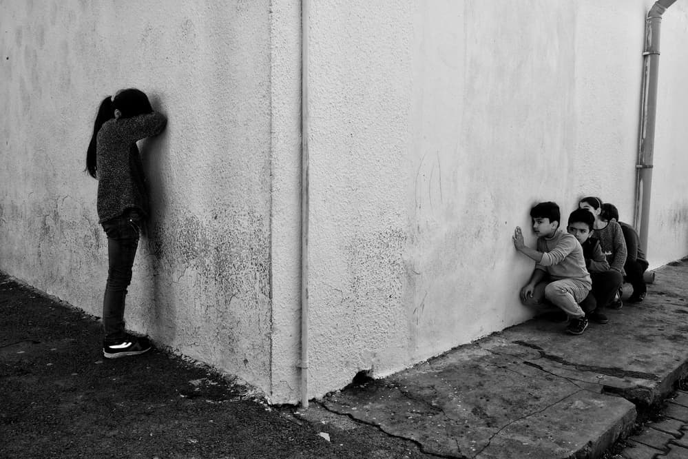 Kids Playing Hide-and-Seek by Ali Ayer — canvas wall art