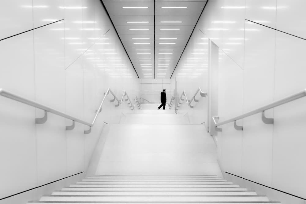 Solitary Figure White Corridor by Andy Dauer — canvas wall art