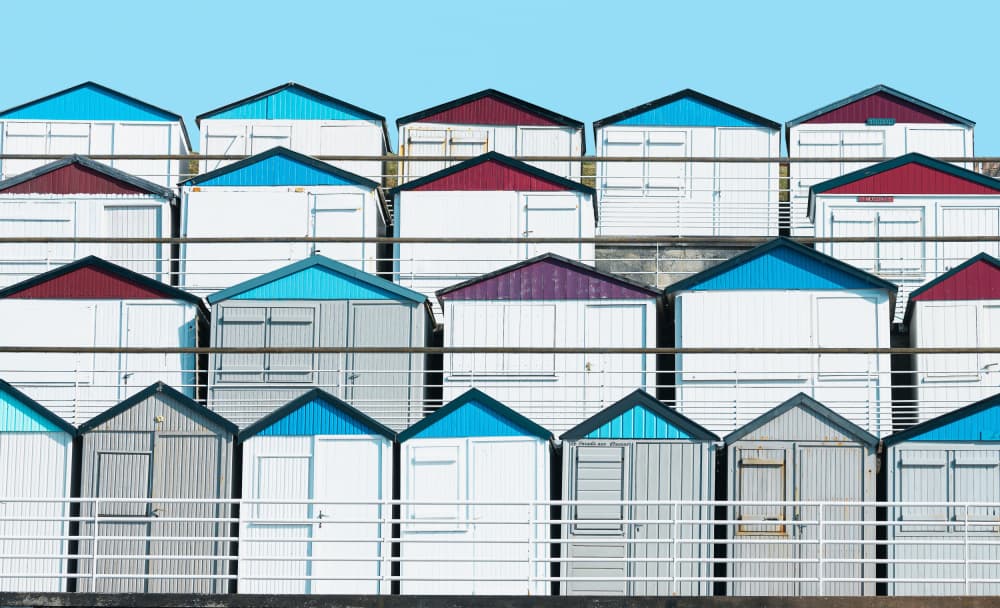 Colorful Beach Huts by Uschi Hermann — canvas wall art