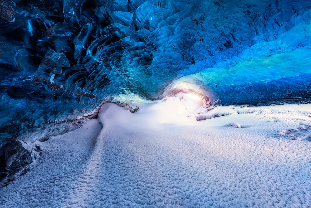Ice Cave Glowing Entrance by David Martin Castan — canvas wall art