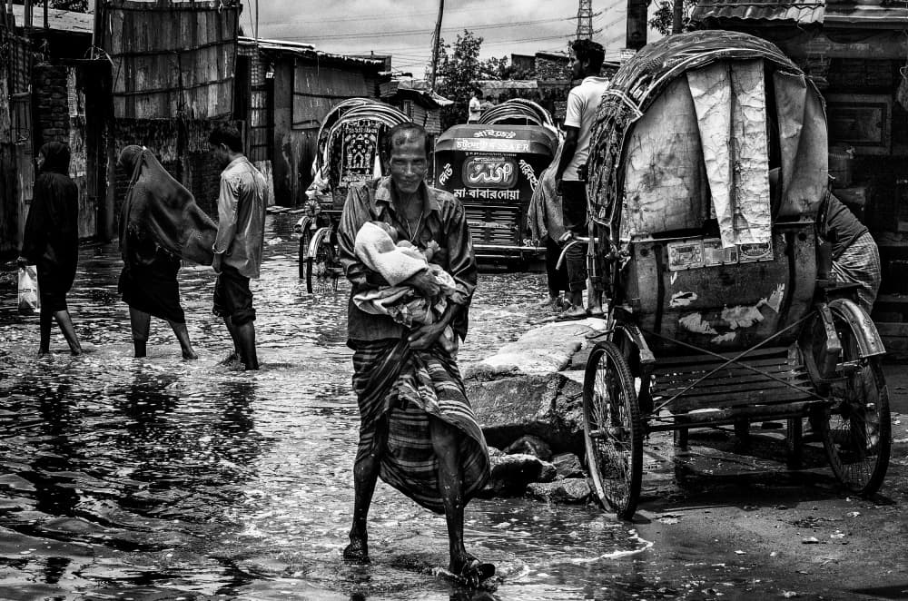 Man Carrying Baby Flood by Joxe Inazio Kuesta Garmendia — canvas wall art