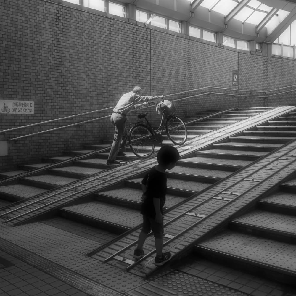 Man Pushing Bicycle Ramp by HISASHI ISHIKAWA — canvas wall art
