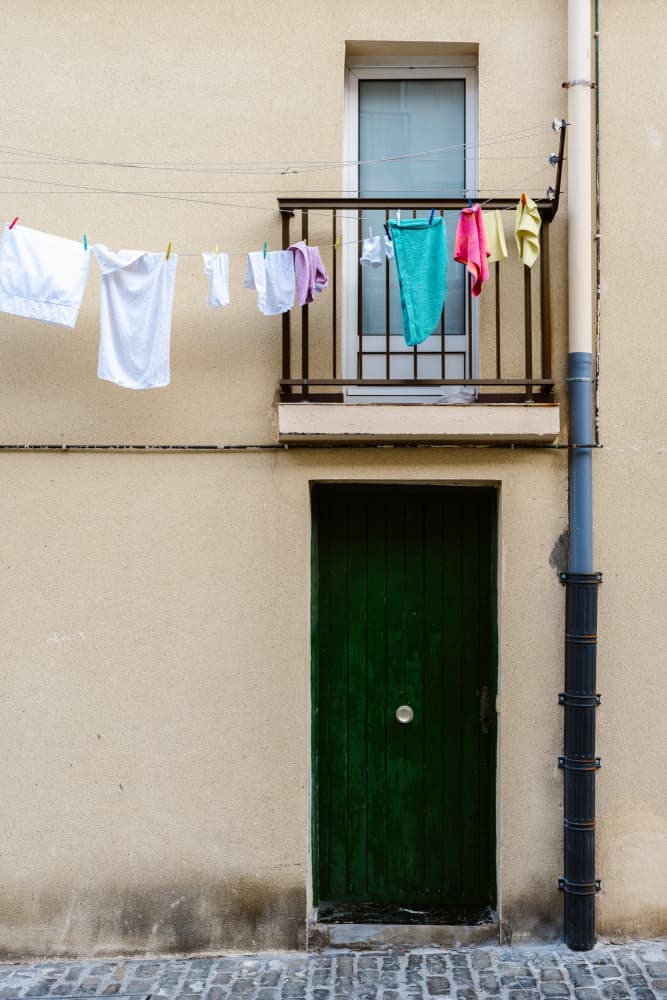 Hanging Laundry Green Door by Aimee Giles — canvas wall art