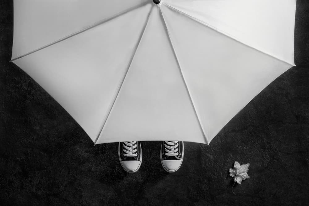 Feet Under White Umbrella by Stephen Clough — canvas wall art