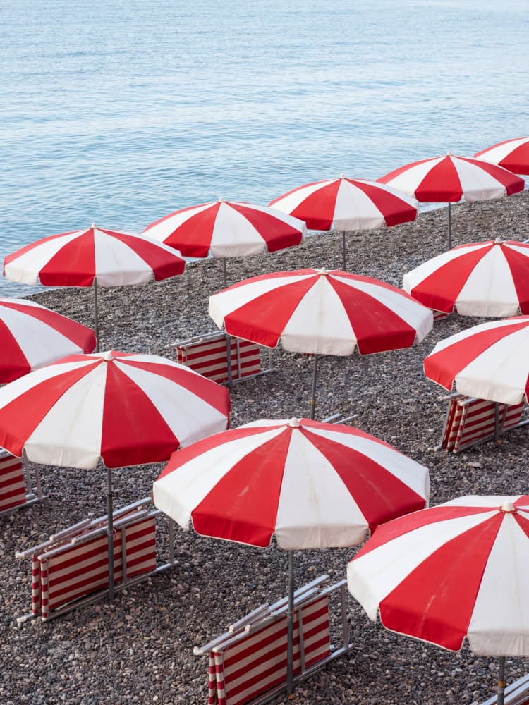Red Striped Beach Umbrellas by Andreas Magnusson — canvas wall art