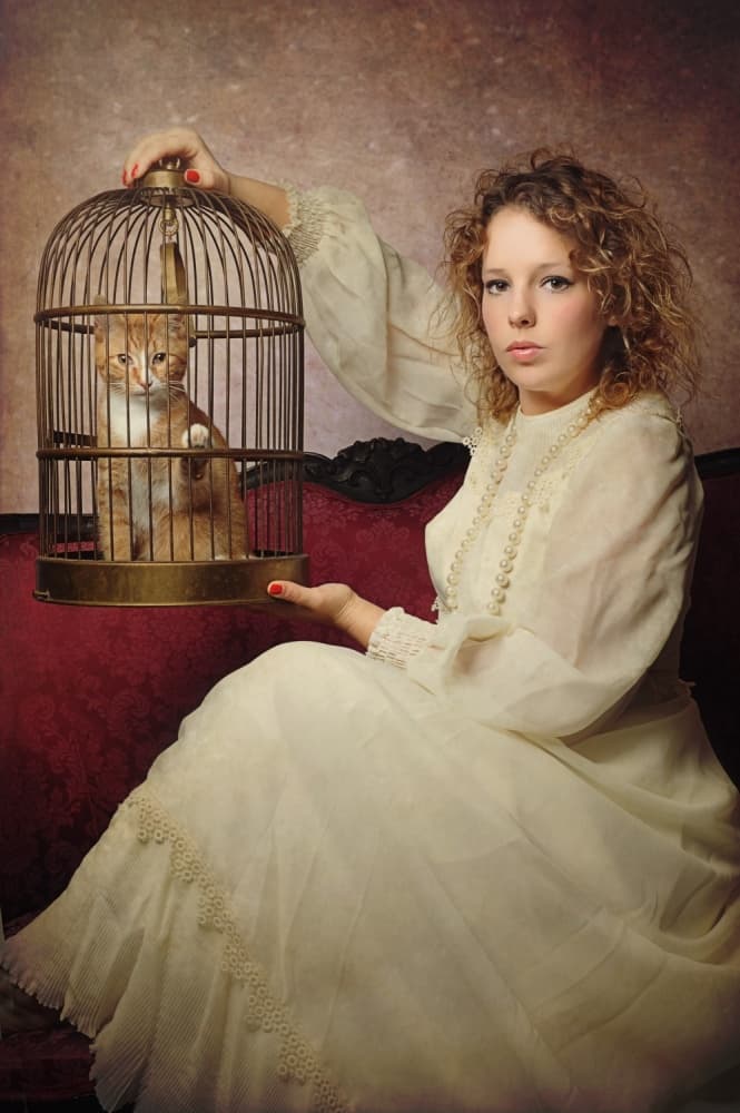 Elegant Woman Caged Kitten by Monika Vanhercke — canvas wall art