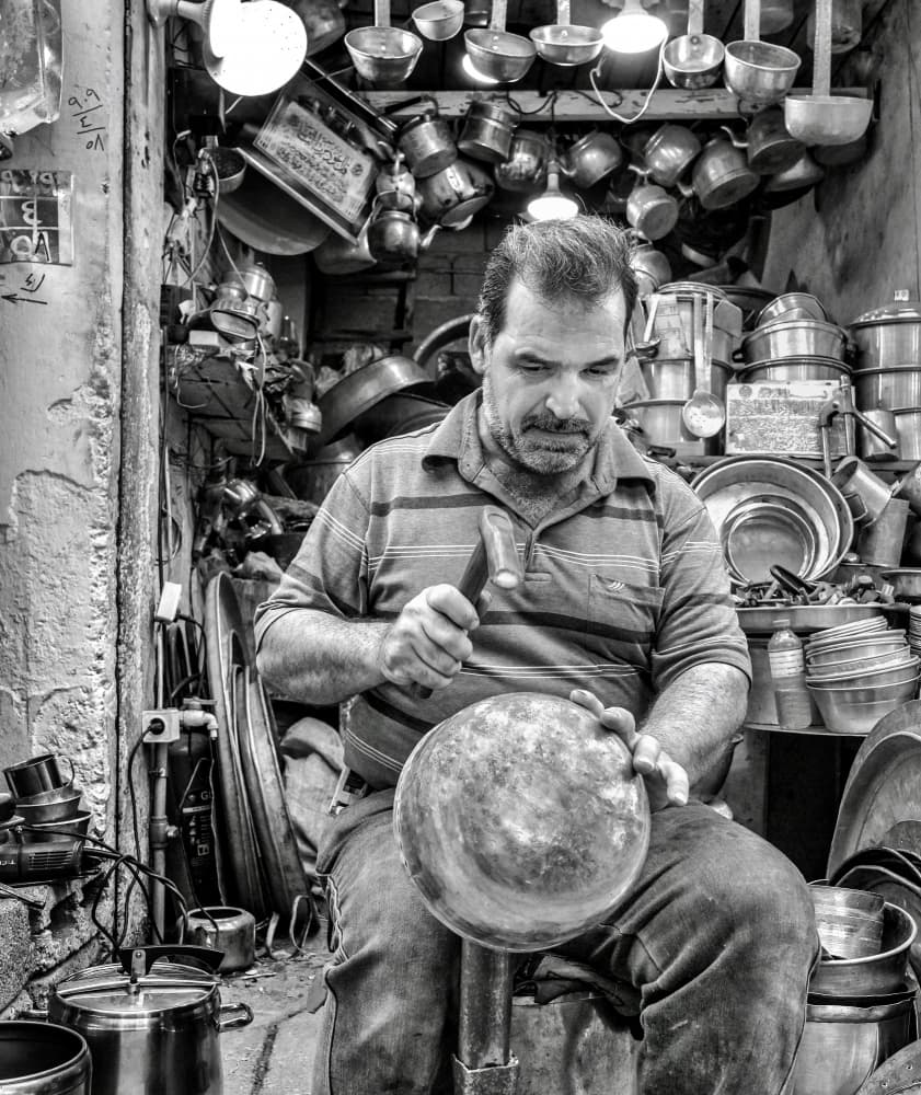 Artisan Shaping Metal by Bashar Alsofey — canvas wall art
