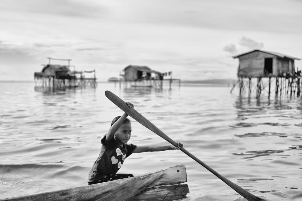 Village Child Paddles by Kieron Long — canvas wall art