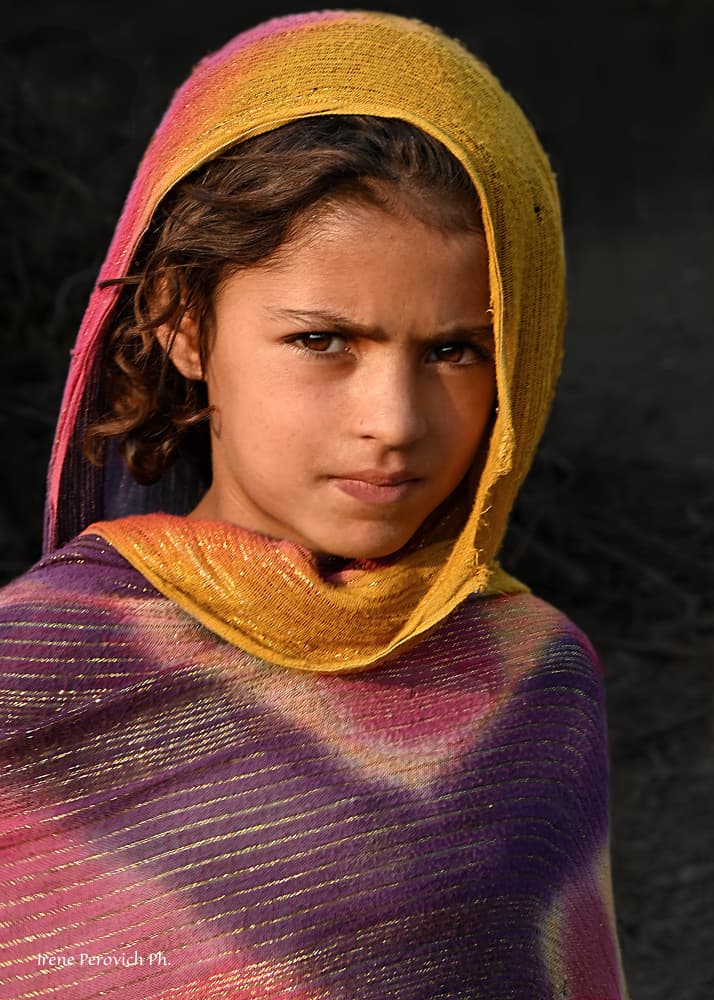 Young Girl's Colorful Gaze by Irene Perovich — canvas wall art