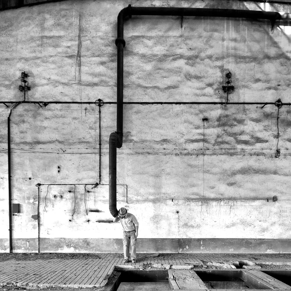 Industrial Man Looking Down by Carlo Ferrara — canvas wall art