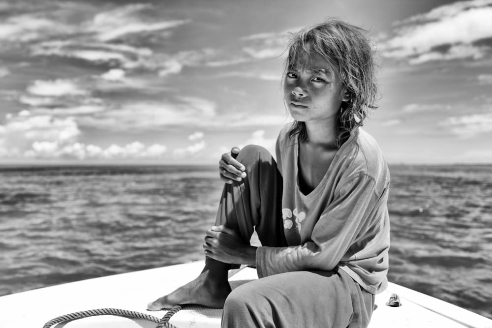 Young Girl on Boat by Kieron Long — canvas wall art