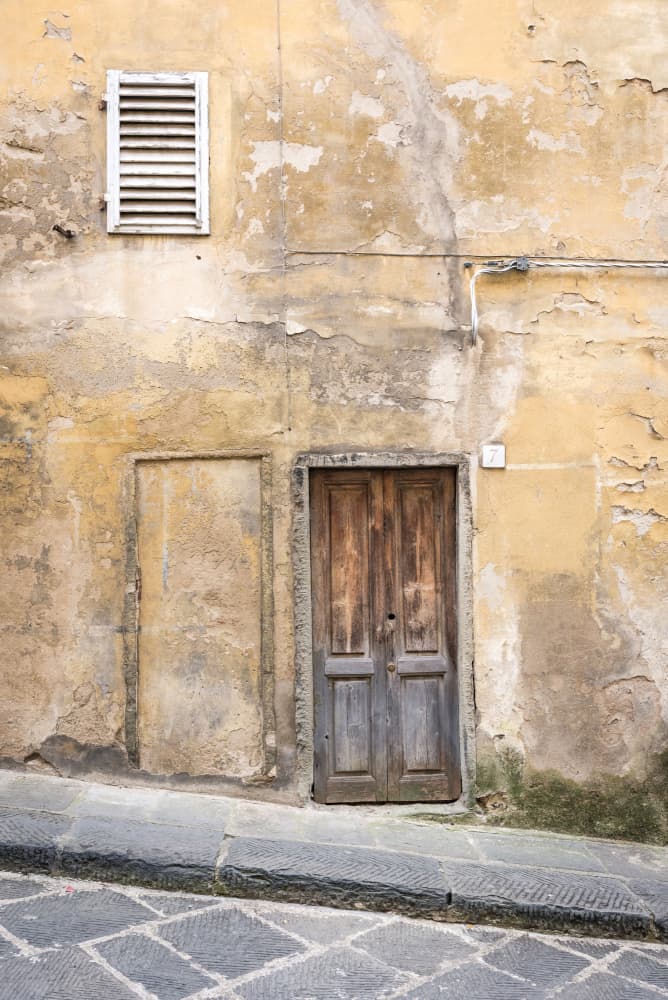 Vintage wall with wooden door in Italy by Photolovers — canvas wall art