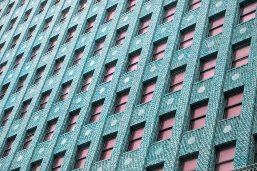 Brick Building with Pink Windows by Tom Windeknecht — canvas wall art