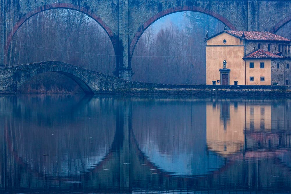 Tranquil Bridge Reflections by Massimo Della Latta — canvas wall art