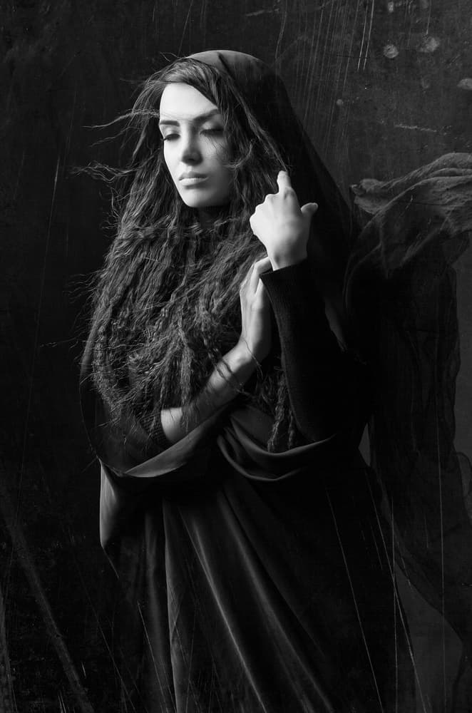 Somber Hooded Woman Portrait by Mehdi Mokhtari — canvas wall art