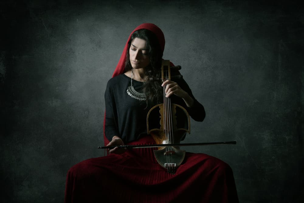 Red Hooded Musician by Moein Hasheminasab — canvas wall art