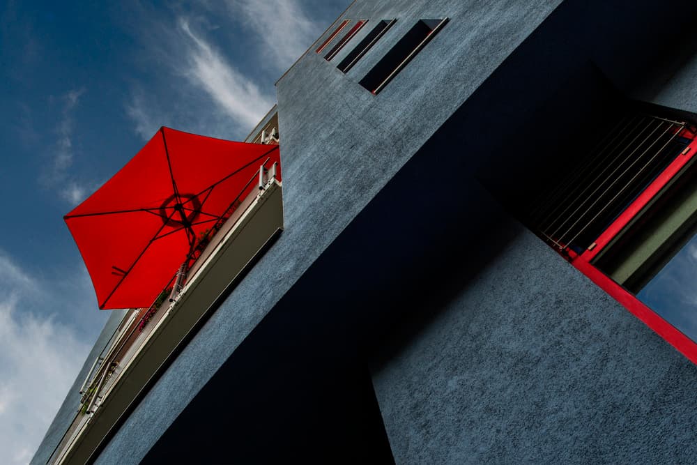 Red Umbrella Balcony by Gerard Jonkman — canvas wall art