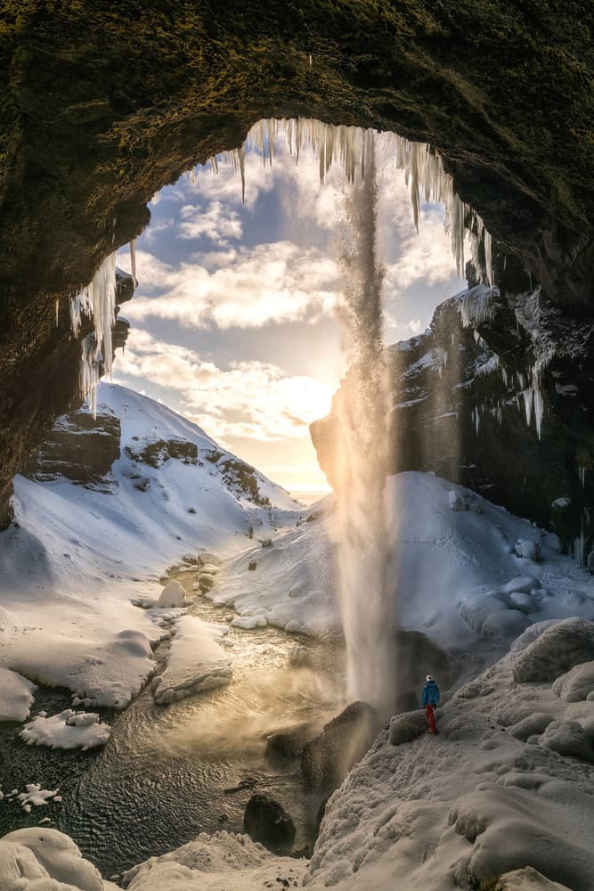 Sunlit Ice Cave Waterfall by Álvaro Pérez & Jose M. Pérez. Brothers — canvas wall art