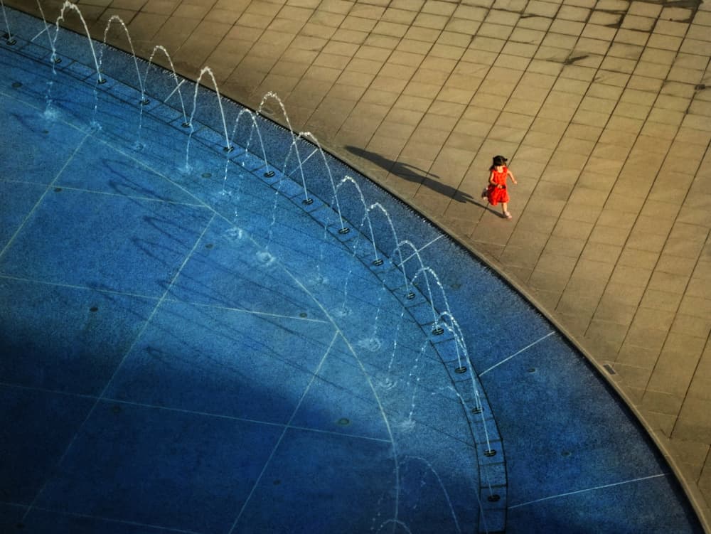 Girl Running By Fountain by Yi-Tang Wang — canvas wall art