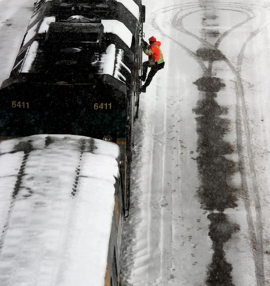 Working on a train in the snow. by Jian Wang — canvas wall art