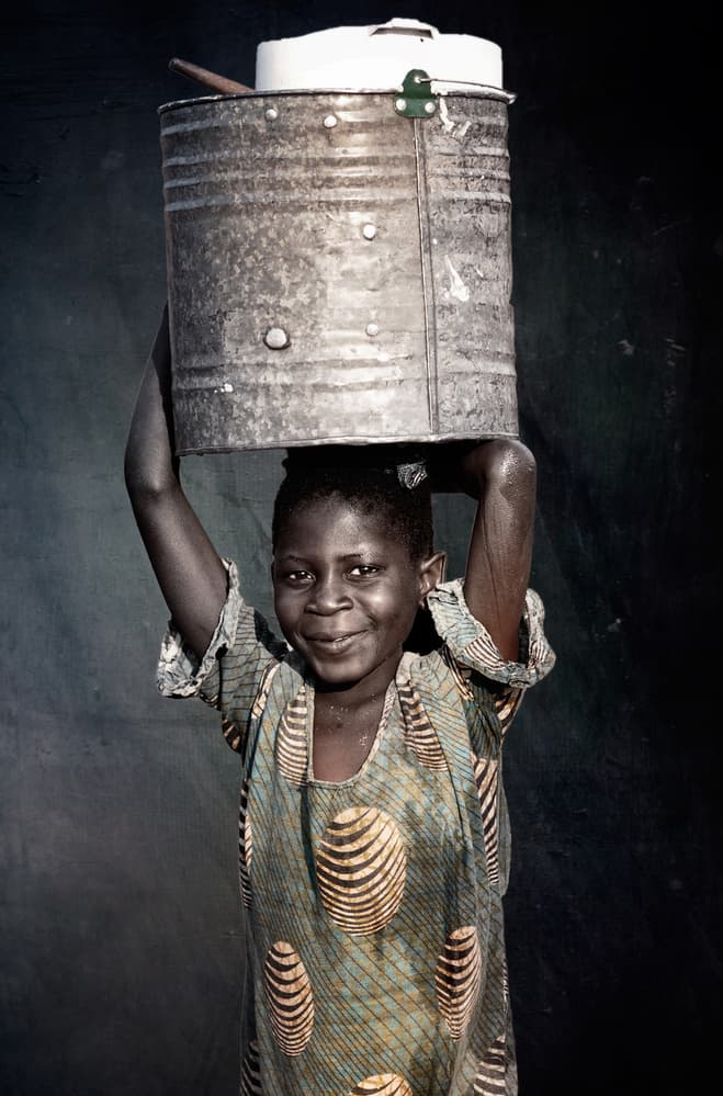 Smiling Girl Carrying Water by Antonio Grambone — canvas wall art