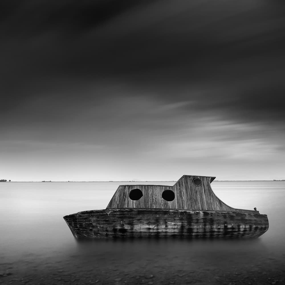 Wooden Boat on Calm Water by George Digalakis — canvas wall art