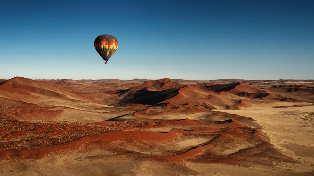 Red Dunes Balloon Flight by Mathilde Guillemot — canvas wall art