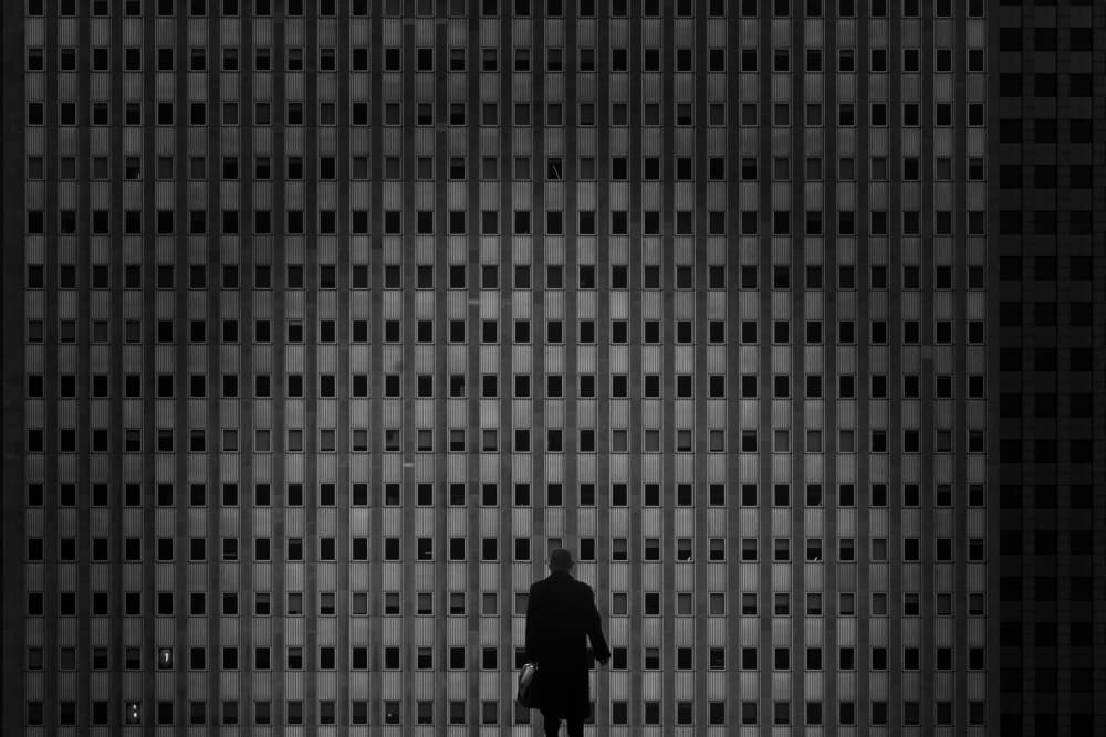 Man Against City Grid by Ramiz Sahin — canvas wall art