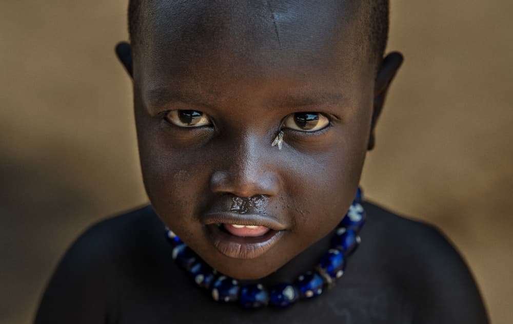 African Child Blue Beads by Joxe Inazio Kuesta Garmendia — canvas wall art