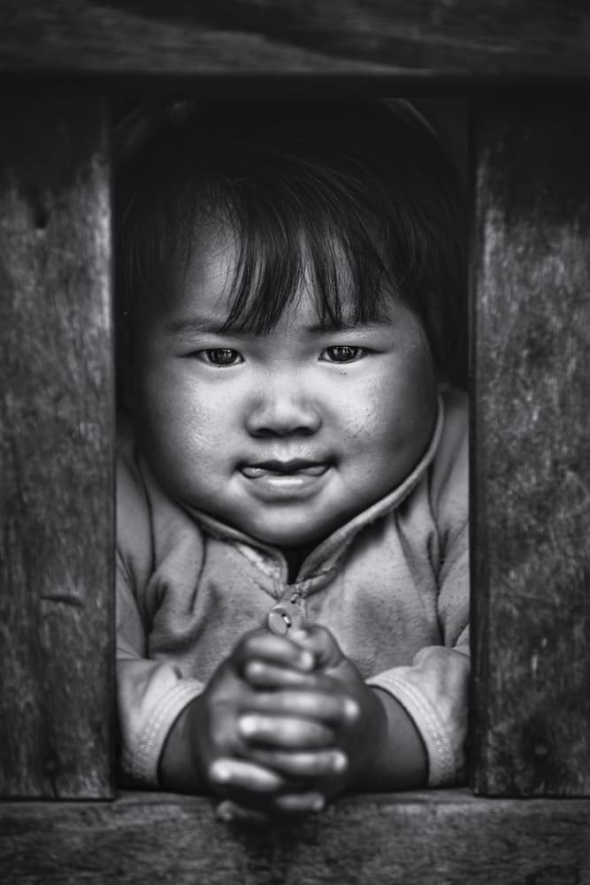 Playful Child Peeking by Marco Tagliarino — canvas wall art