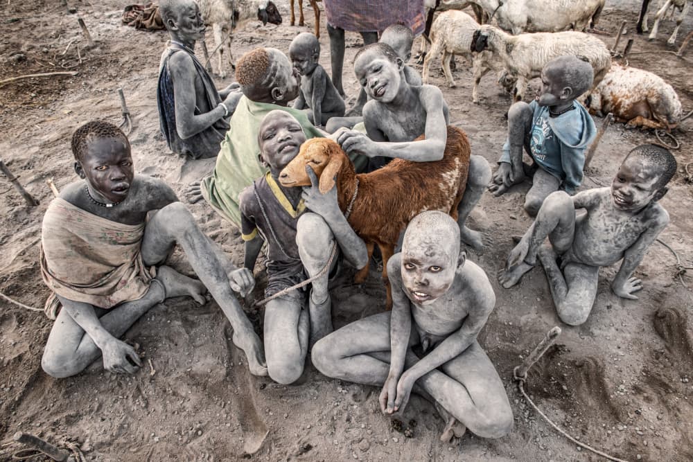 Smiling Children with Goat by Trevor Cole — canvas wall art