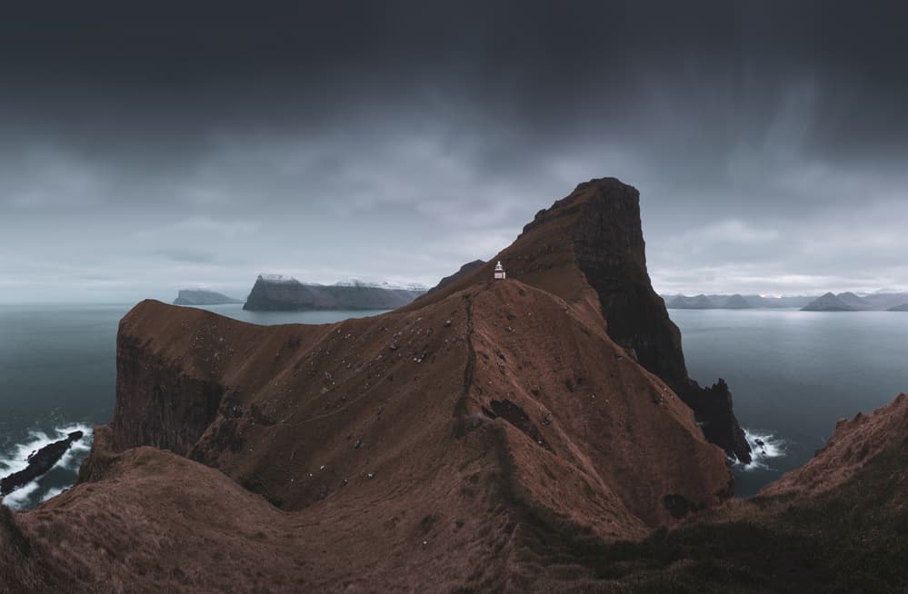 Moody Cliffside Lighthouse by Tony Xu — canvas wall art