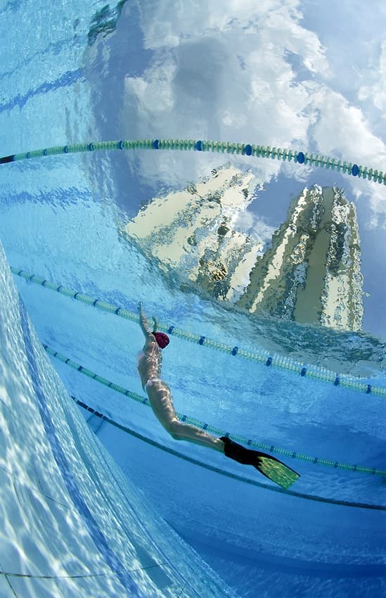 Swimmer Beneath Blue Sky by Andrey Narchuk — canvas wall art