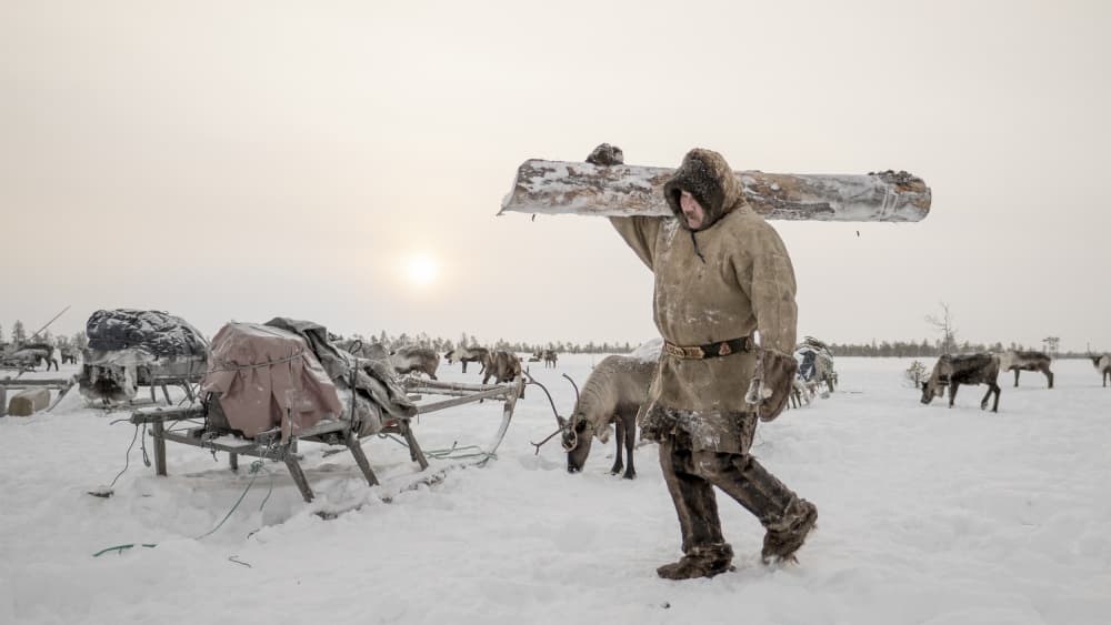 Arctic Man Carrying Log by Marcel Rebro — canvas wall art
