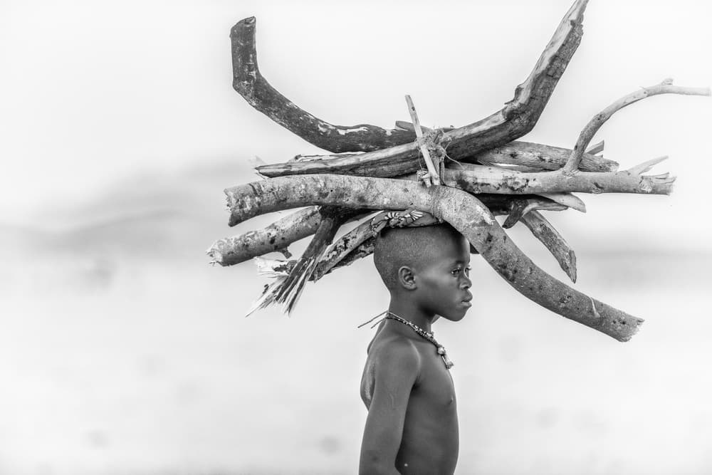 African Boy Carrying Wood by Trevor Cole — canvas wall art