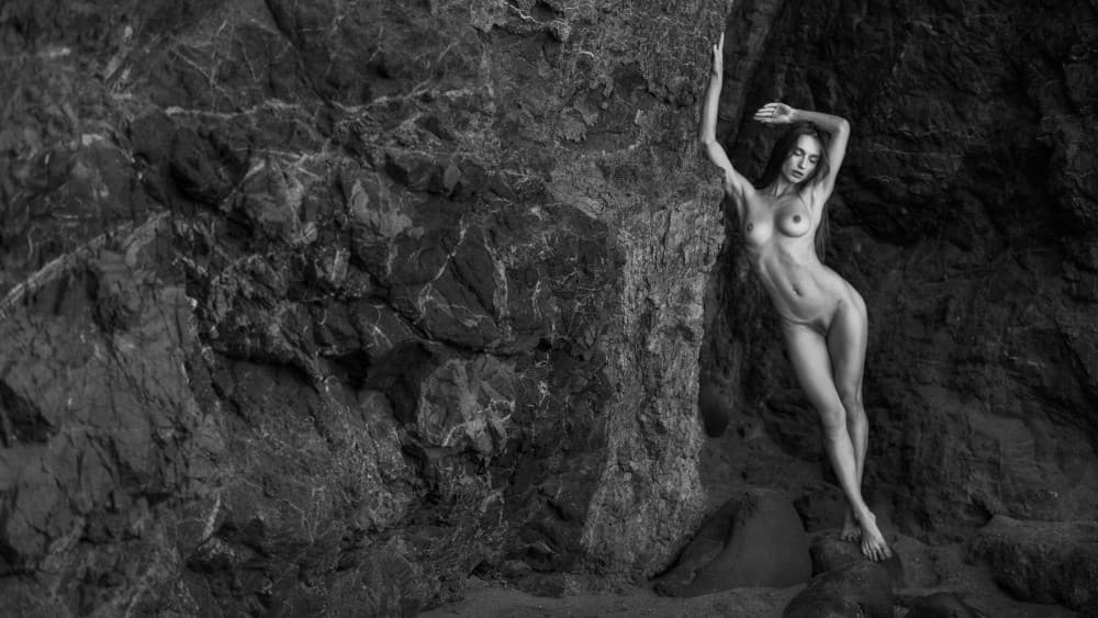 Elegant Nude Against Rocks by Joan Gil Raga — canvas wall art