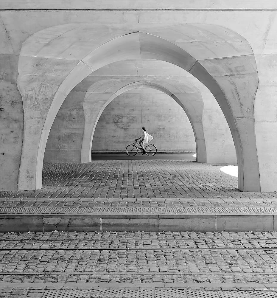 Cyclist Under Arches by Andreas Timar — canvas wall art