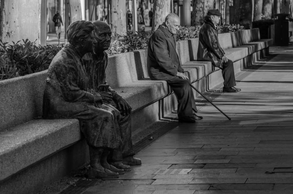 Street Bench Statues by PacodlaCorte — canvas wall art