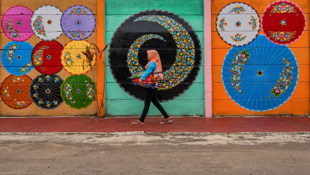 Woman Among Umbrella Murals by Gunarto Song — canvas wall art