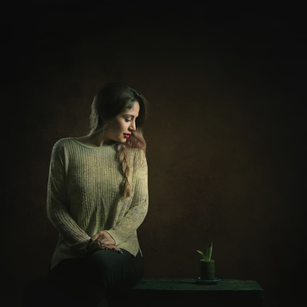 Pensive Woman with Plant by Moein Hasheminasab — canvas wall art