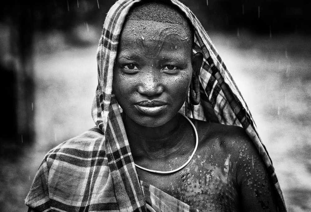 African Woman in Rain by Joxe Inazio Kuesta Garmendia — canvas wall art