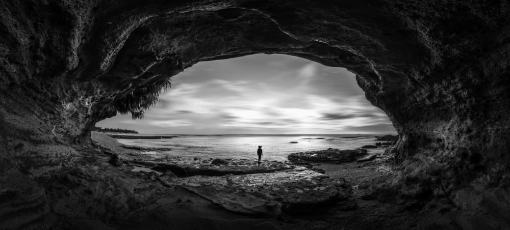 Lone Figure Sea Cave by Irene Wu — canvas wall art