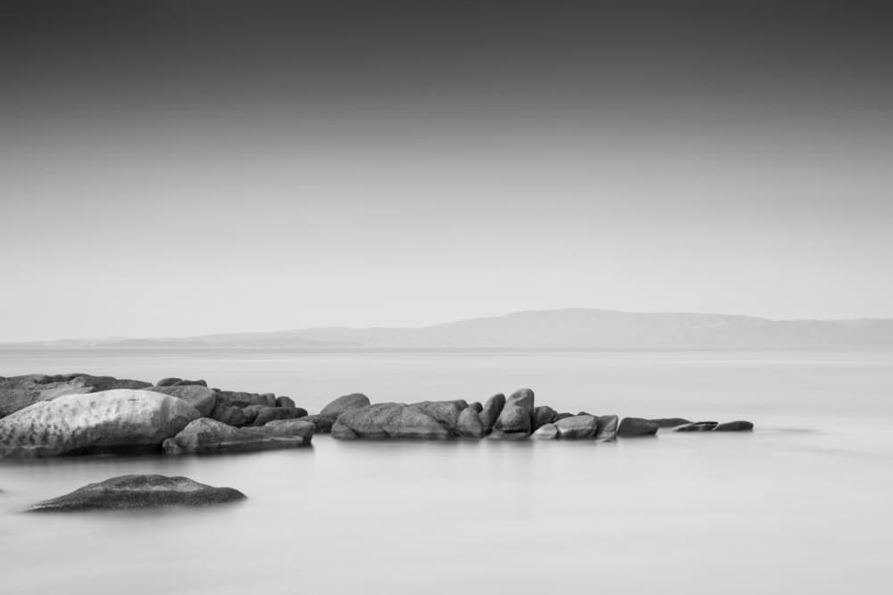 Calm Coastal Stones by Catalin Baican — canvas wall art