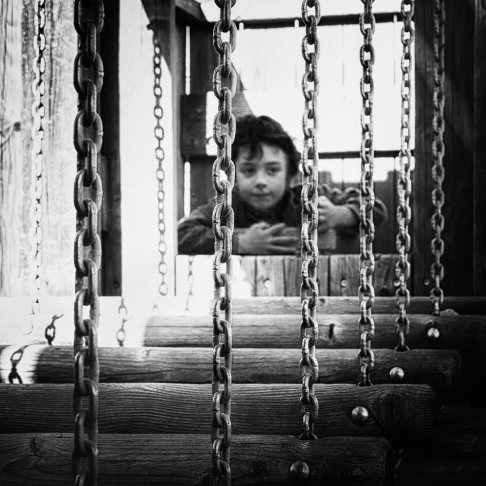 Boy Behind Chains by Laura Mexia — canvas wall art