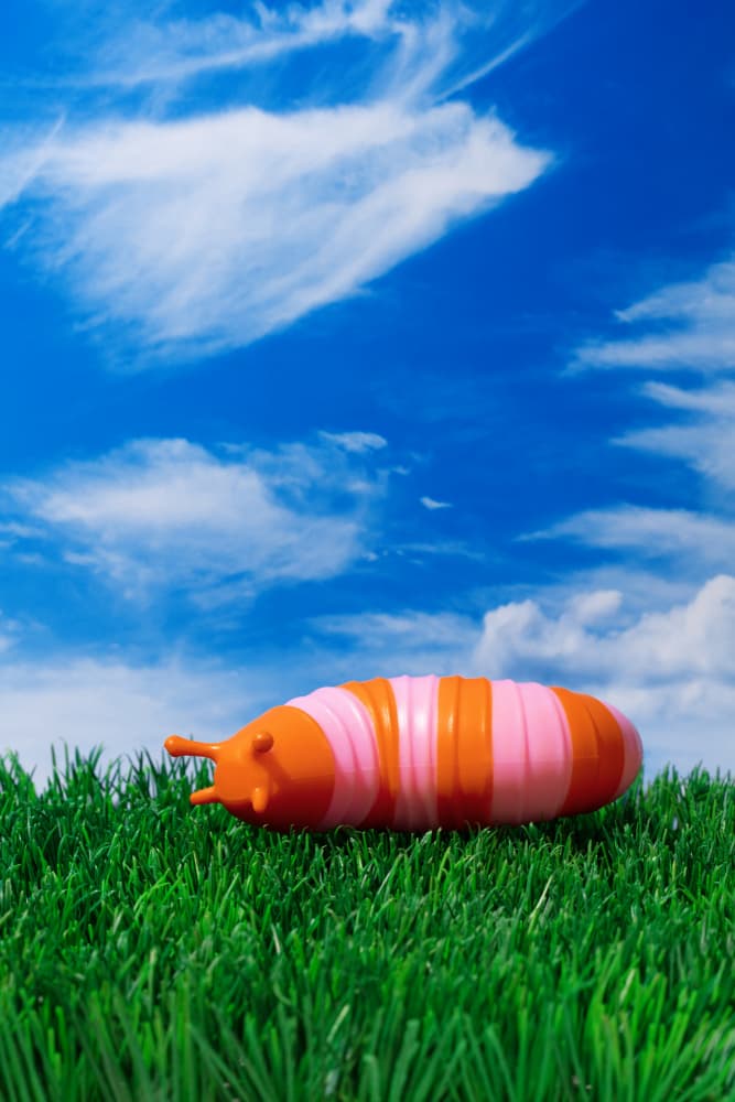 Playful Caterpillar Under Blue Sky by Julia Ramiro — canvas wall art